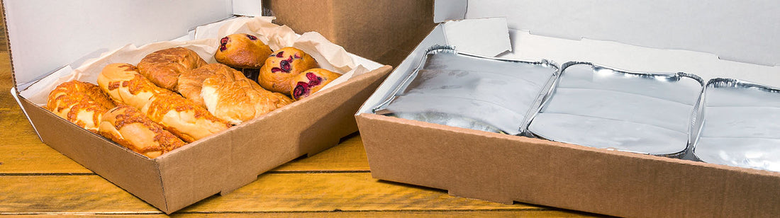 two corrugated catering boxes, one with baked goods and the other with 3 aluminum plans