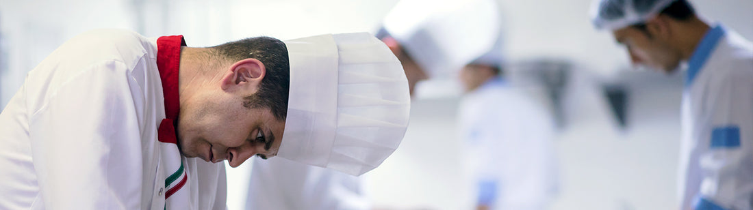 Benjamin in his chef uniform wearing a fluted chef hat