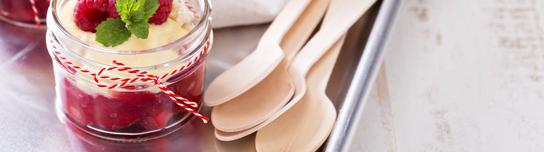 strawberry dessert next to some primeware wooden spoons