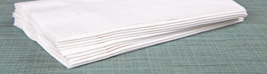 small stack of folded white dinner napkins