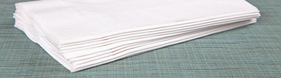 small stack of folded white dinner napkins