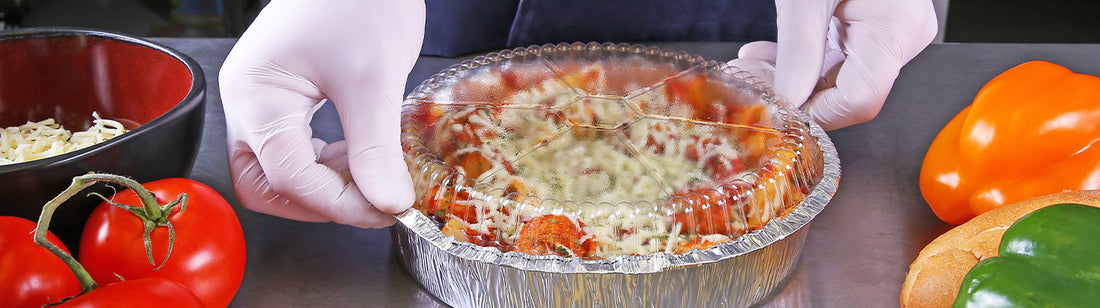 little deep dish pizza in a round aluminum pan