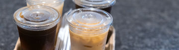 a tray with 4 cold drinks in clear PET cups
