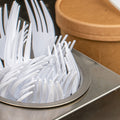 white plastic cutlery organized by type