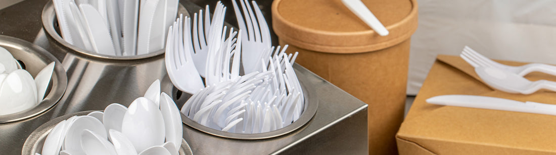 white plastic cutlery in steel cutlery holder
