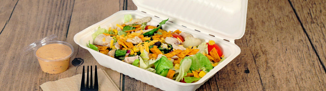 a classic taco salad in a 9" x 6" molded fiber container with the sauce on the side.