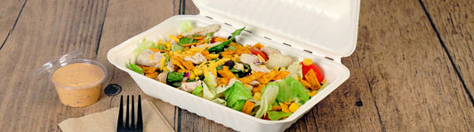 a classic taco salad in a 9" x 6" molded fiber container with the sauce on the side.