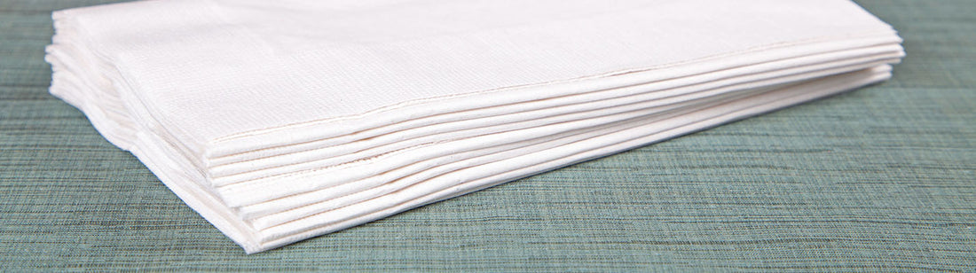 small stack of folded white dinner napkins 