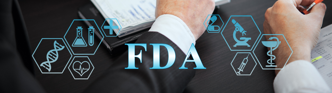 people signing a paper with overlay that says FDA
