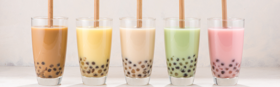 5 different colored boba teas on a table