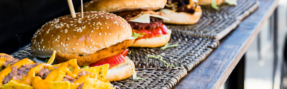 specialty burgers set out on a counter