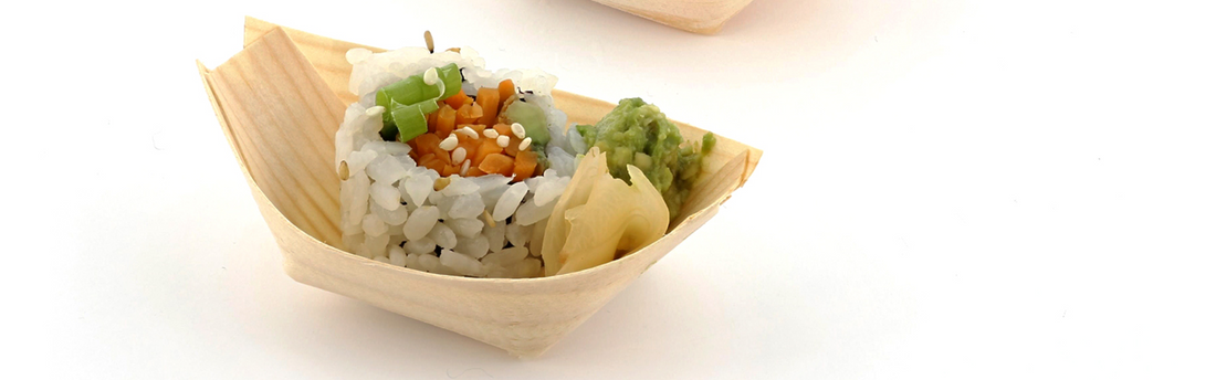 bamboo serving boats with a single piece of sushi inside