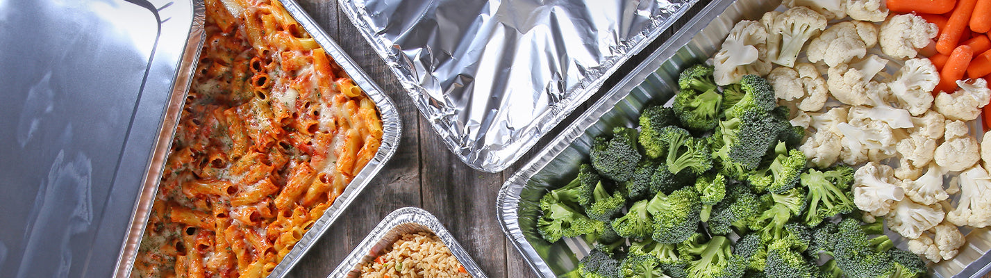 catering food boxes, one with food one with aluminum pans inside