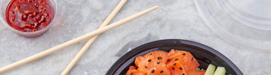 bamboo chopsticks next to takeout food