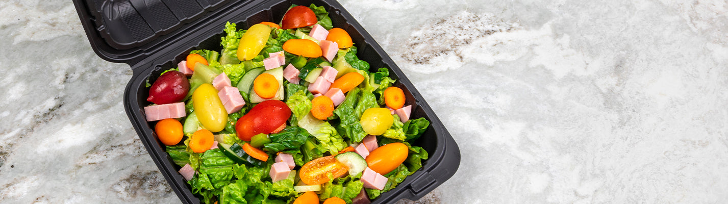 black mineral filled container with fresh salad inside