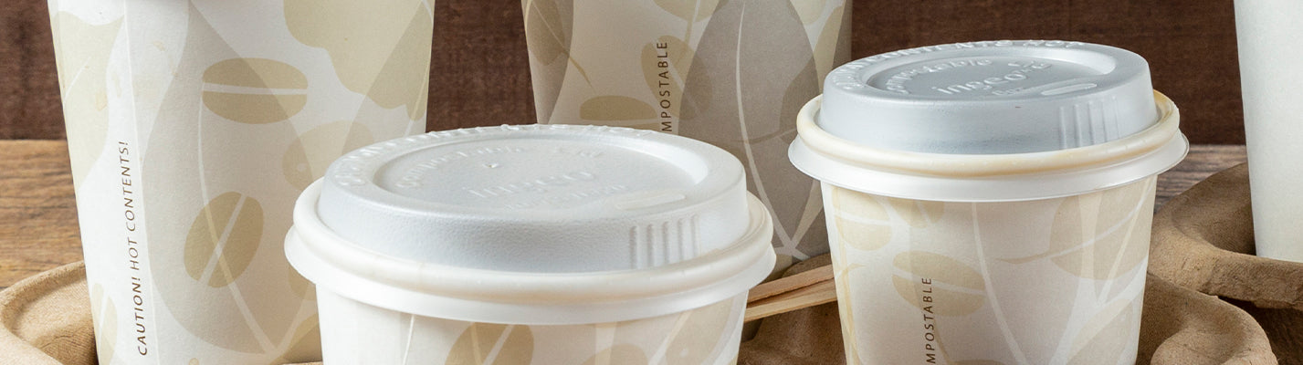 two white hot cups and a chocolate chip muffin