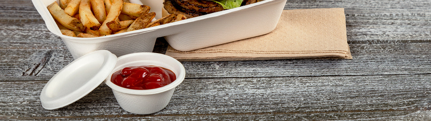 a 2 oz molded fiber portion cup filled with ketchup and a matching lid to the side