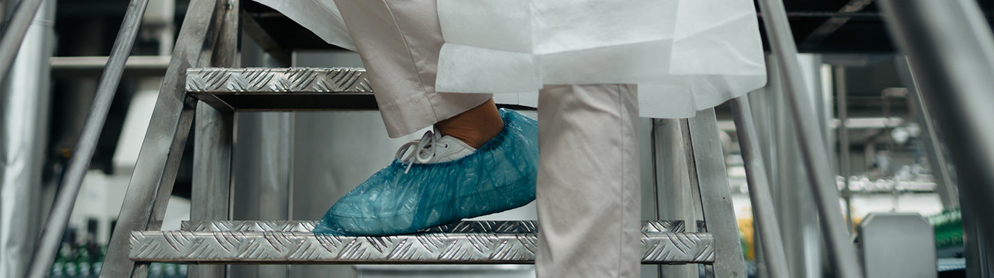Boris is keeping their hands safe with our signature yellow neptune latex gloves while cleaning a metal bowl