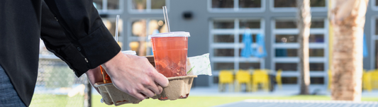 Virginia carrying a tray of cold drinks in CPLA cold cups with cellulosic clear compostable straws inside