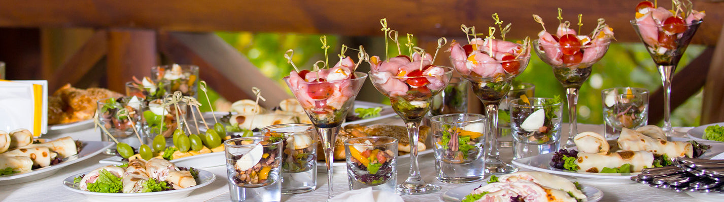 Food table with all sorts of fancy hors d'oeuvres with party picks in them