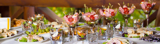 Food table with all sorts of fancy hors d'oeuvres with party picks in them