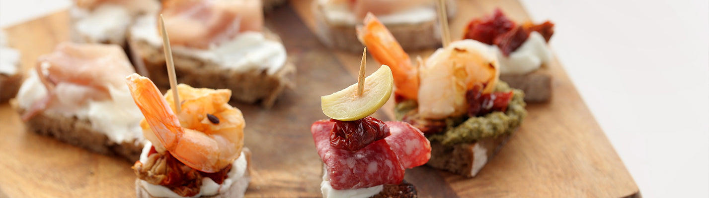 little hors d'oeuvres with food picks holding them together