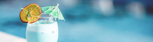 green umbrella party pick in a colorful cocktail