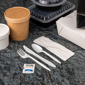 cutlery kit opened and laid out on the counter next to take out dishes