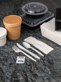 cutlery kit opened and laid out on the counter next to take out dishes