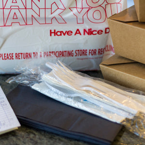 Bag of takeout with cutlery kit to the side