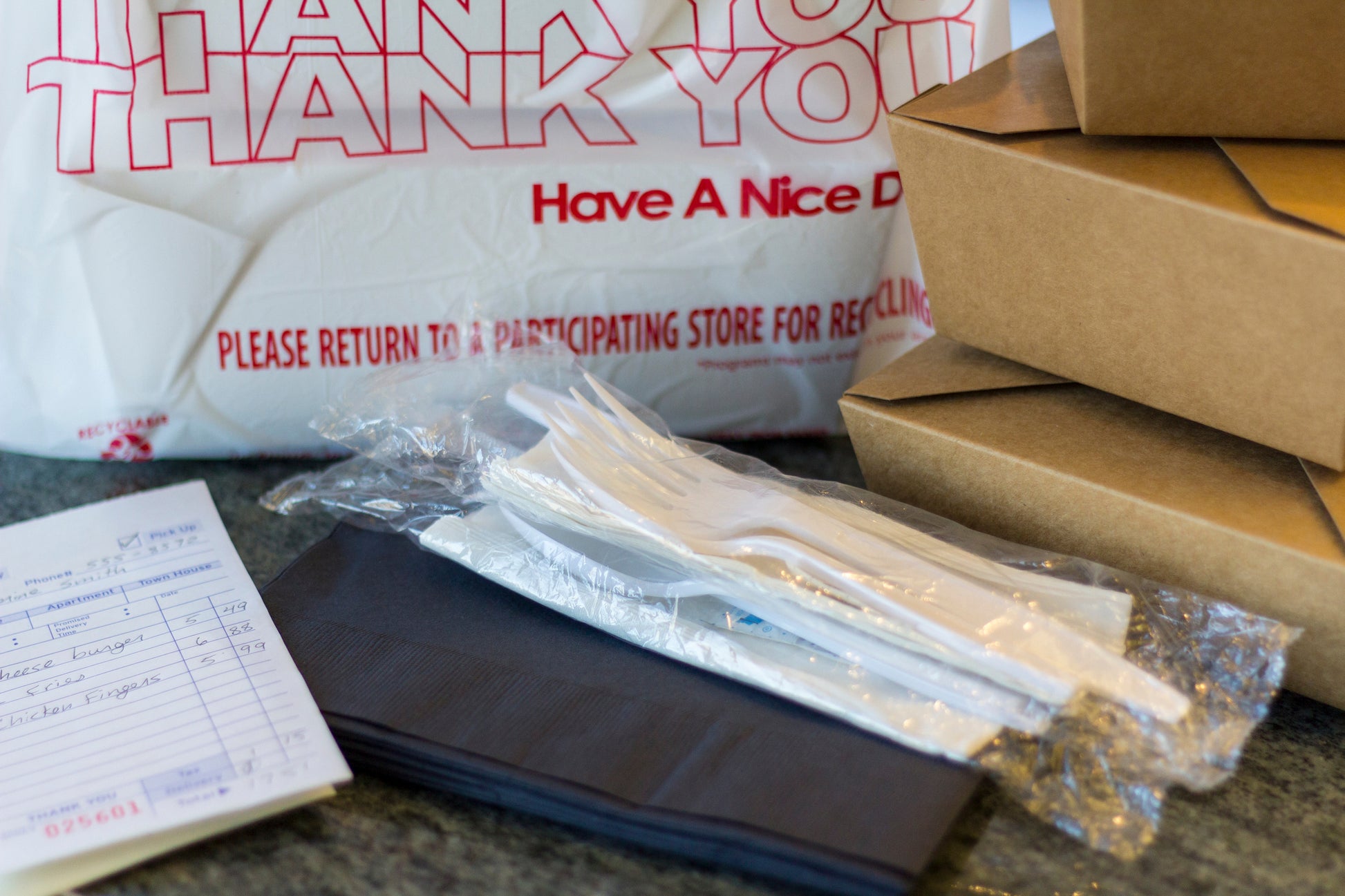 Bag of takeout with cutlery kit to the side
