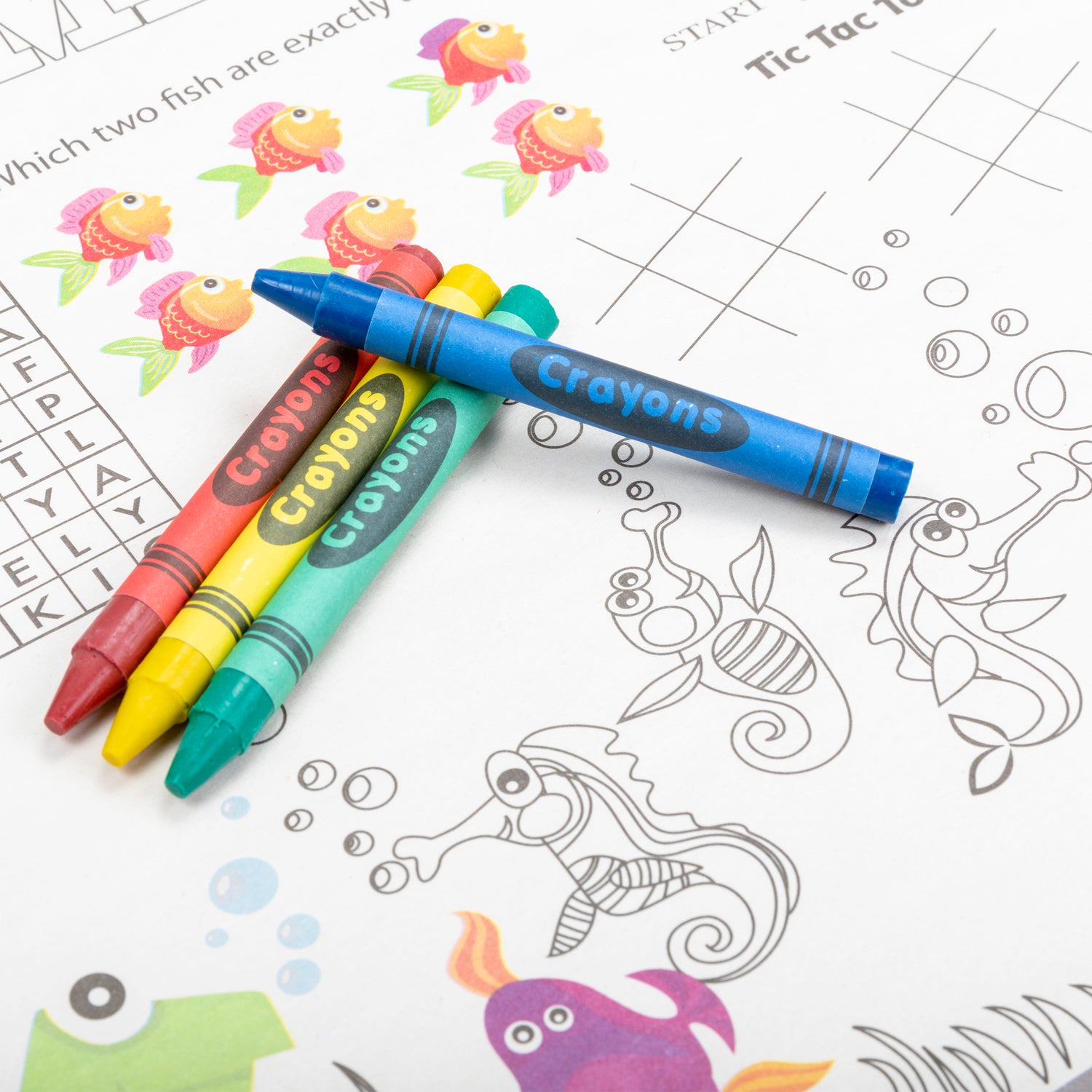 red, yellow, green and blue crayons on a coloring placemat