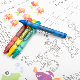 red, yellow, green and blue crayons on a coloring placemat