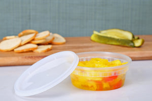 8 oz deli container with fresh cut sweet peppers in it and matching lid to the side