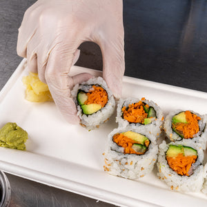 Person placing fresh sushi on a 10" x 5" Heavy Molded Rectangle Fiber Plates
