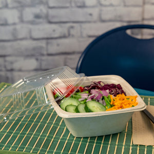 salad in a 32 oz square tan bowl with clear matching lid to the side