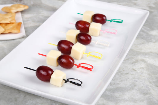 Cheese and grapes on multi-colored sword pics