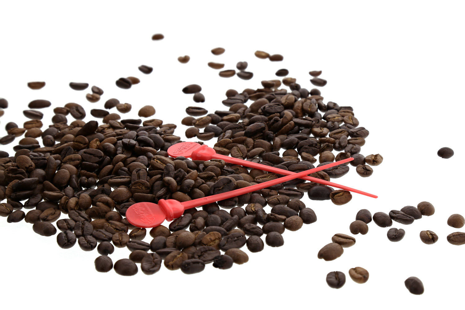 two 4.75" Red Stir Stix Plugs over some coffee beans