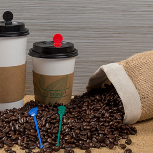 two white hot cups with cup sleeves on them, spilled back of coffee beans in front with 4.75