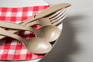 disposable wheat cutlery on a red gingham napkin